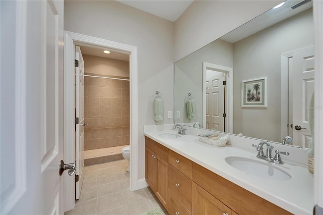 full bathroom featuring toilet, tile patterned flooring, a sink, and visible vents