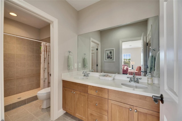 ensuite bathroom with a stall shower, double vanity, a sink, and ensuite bathroom