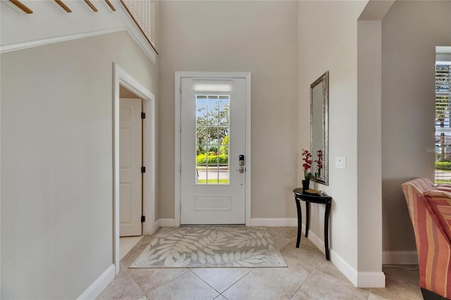 entrance foyer featuring light tile patterned floors and baseboards