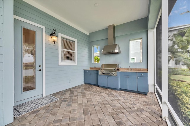 interior space featuring exterior kitchen, a sink, and area for grilling