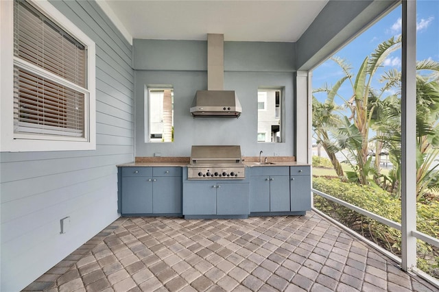 exterior space featuring exterior kitchen, area for grilling, and a sink