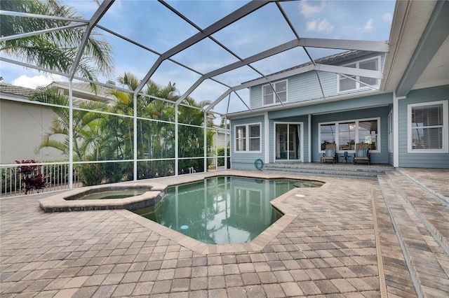 view of swimming pool with a pool with connected hot tub, glass enclosure, and a patio