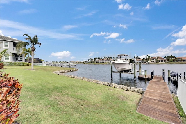 view of dock with a water view, a lawn, and boat lift