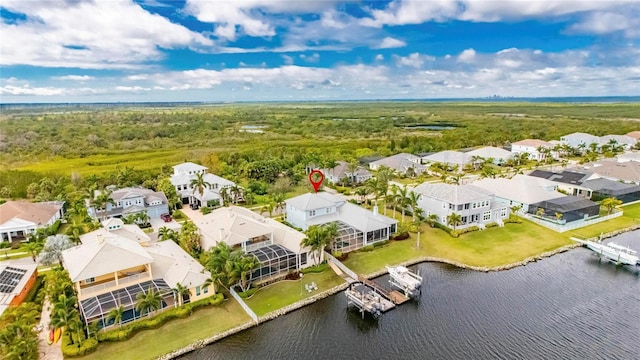 birds eye view of property with a water view and a residential view