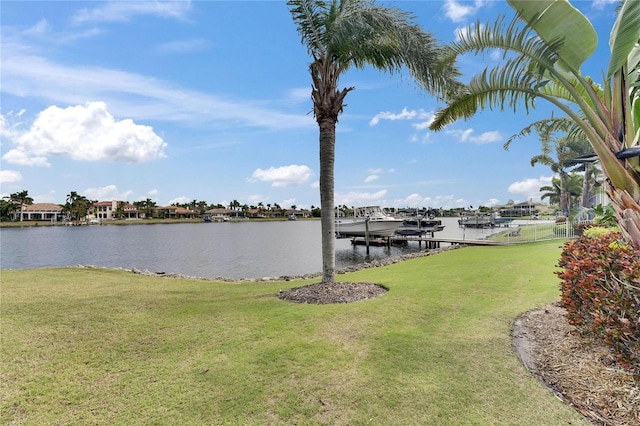 dock area with a water view and a lawn