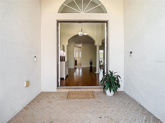 doorway to property featuring stucco siding