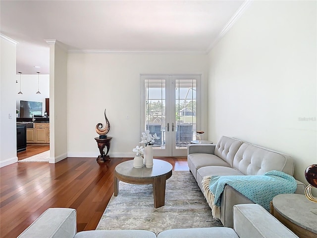 living room featuring french doors, baseboards, wood finished floors, and ornamental molding