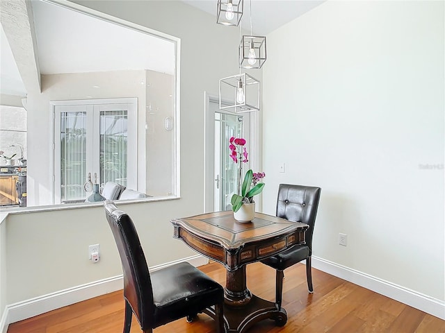 dining area featuring baseboards and wood finished floors