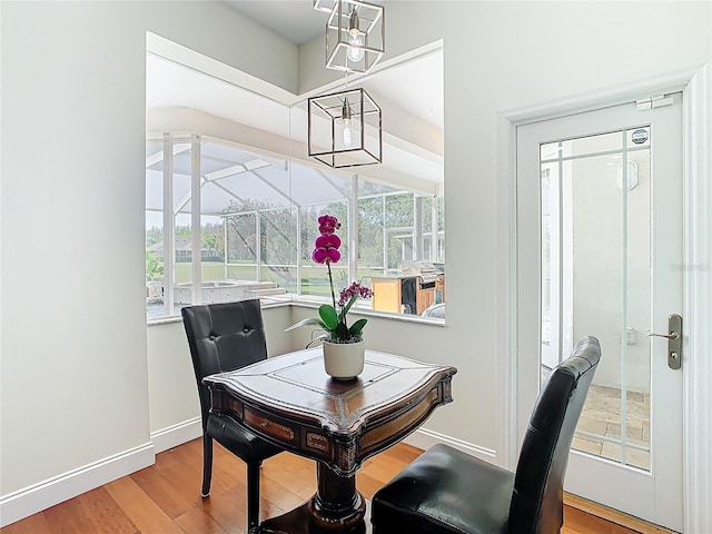 dining room featuring baseboards, a notable chandelier, and wood finished floors