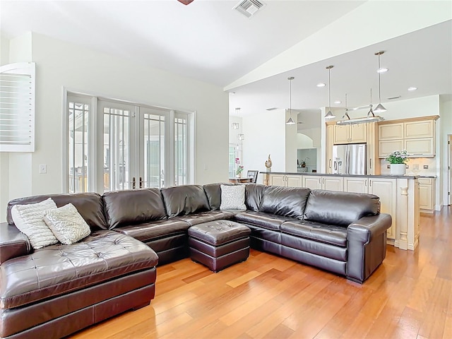 living room featuring recessed lighting, visible vents, light wood-style flooring, and lofted ceiling