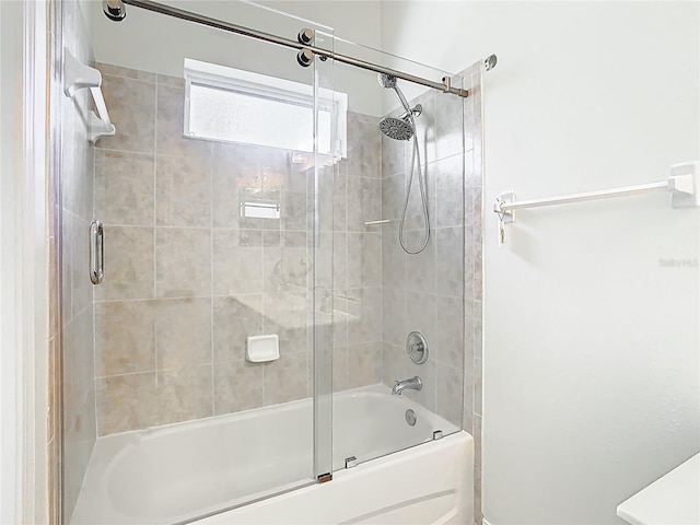 bathroom featuring bath / shower combo with glass door