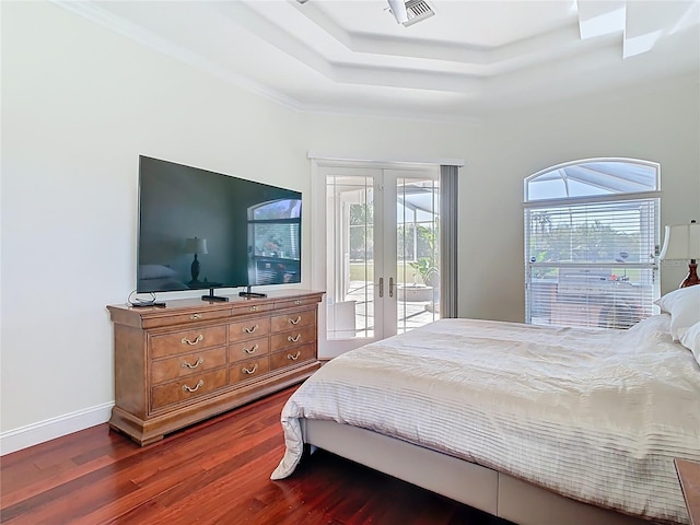 bedroom with access to exterior, visible vents, a tray ceiling, french doors, and dark wood-style flooring