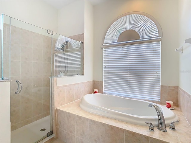 bathroom featuring a garden tub and a stall shower