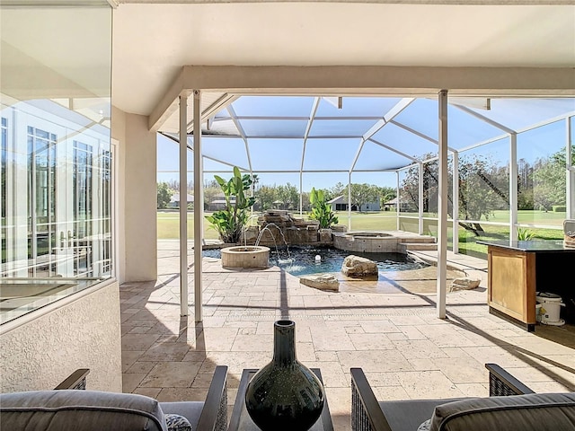 view of patio featuring a lanai and a pool with connected hot tub