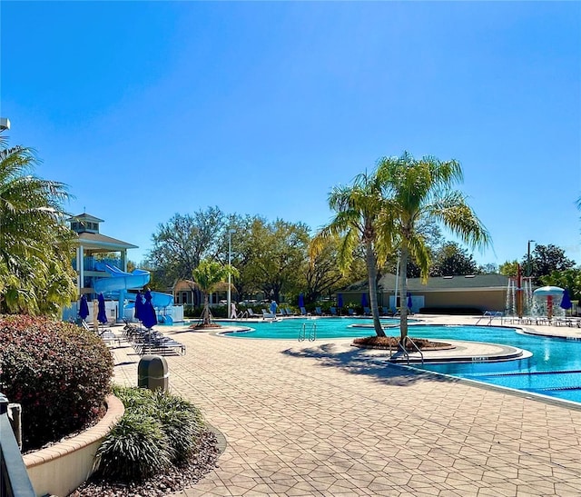 pool featuring fence and a patio area