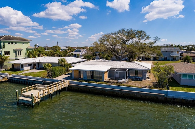 rear view of property featuring a residential view and a water view