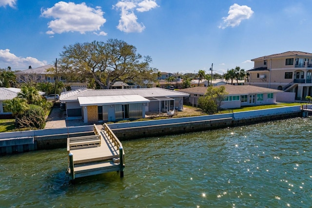 back of property with a water view and a residential view