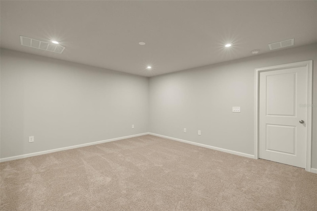 carpeted empty room featuring visible vents and recessed lighting