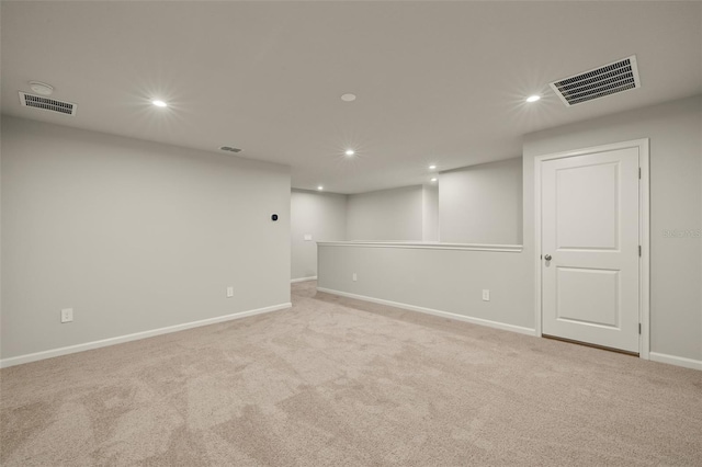 basement featuring baseboards, visible vents, and recessed lighting