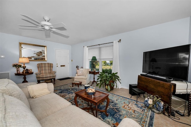 living area featuring light tile patterned floors, ceiling fan, visible vents, and baseboards