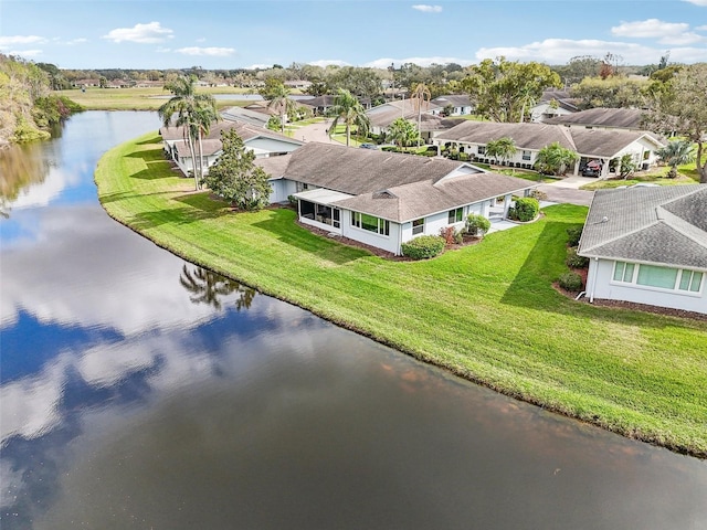 drone / aerial view featuring a water view and a residential view