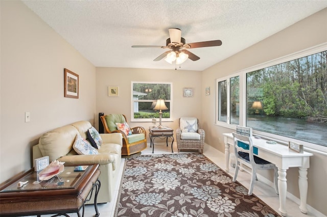 living room featuring a textured ceiling and a ceiling fan