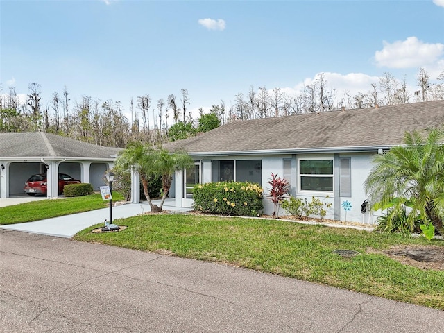 ranch-style home featuring a garage, concrete driveway, roof with shingles, stucco siding, and a front yard