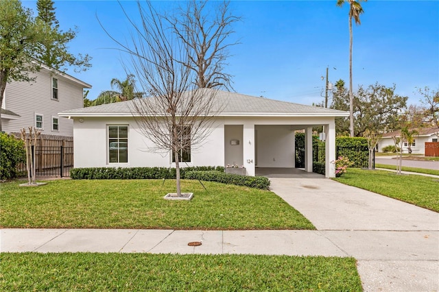 view of front of house with an attached carport, fence, driveway, stucco siding, and a front yard