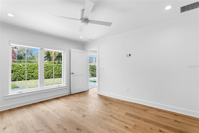 empty room with light wood finished floors, baseboards, visible vents, ornamental molding, and recessed lighting