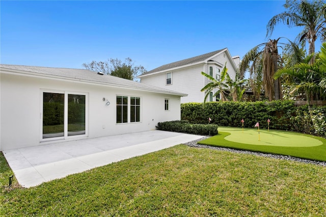 back of property with a patio and stucco siding