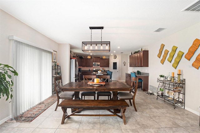 dining room featuring visible vents, baseboards, and light tile patterned flooring