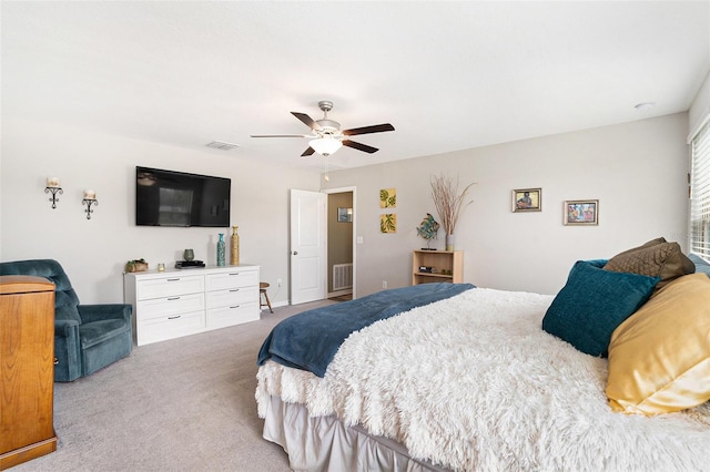 carpeted bedroom with visible vents and a ceiling fan