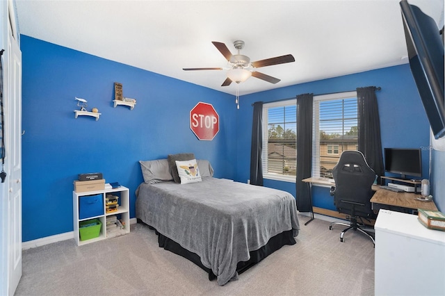 carpeted bedroom featuring ceiling fan and baseboards