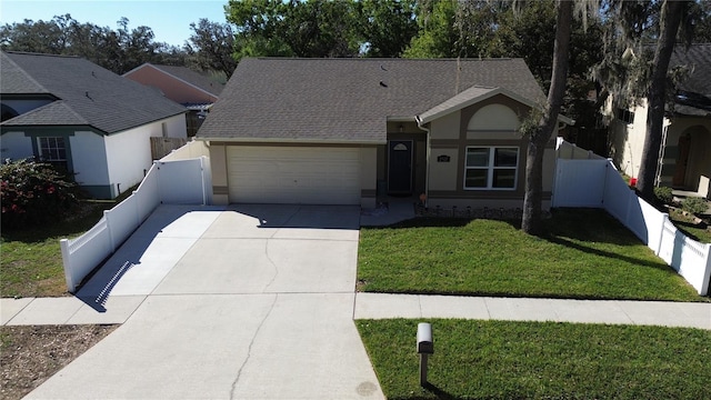 ranch-style house with stucco siding, concrete driveway, a garage, fence private yard, and a front lawn