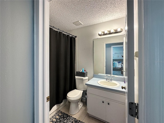 full bath featuring a textured wall, toilet, tile patterned flooring, a textured ceiling, and vanity