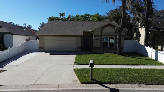 ranch-style home featuring concrete driveway, an attached garage, fence, a front lawn, and stucco siding