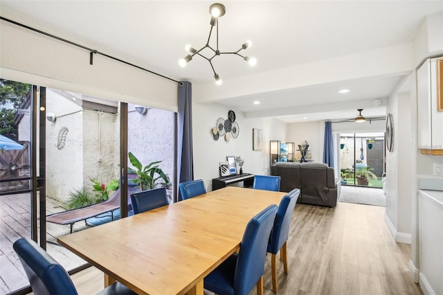 dining room with ceiling fan with notable chandelier, light wood-type flooring, baseboards, and recessed lighting