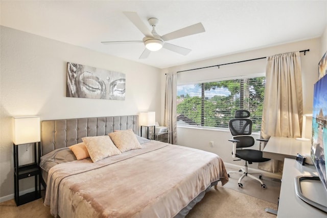 bedroom featuring light colored carpet, ceiling fan, and baseboards