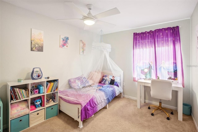 carpeted bedroom with ceiling fan and baseboards