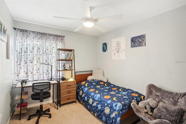 bedroom with light carpet, baseboards, and a ceiling fan