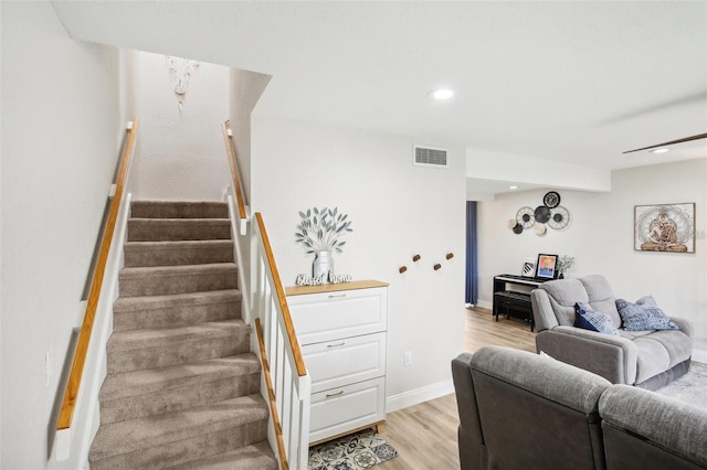 staircase with recessed lighting, visible vents, baseboards, and wood finished floors