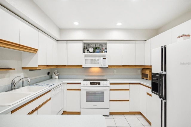 kitchen featuring recessed lighting, white appliances, a sink, white cabinetry, and light countertops