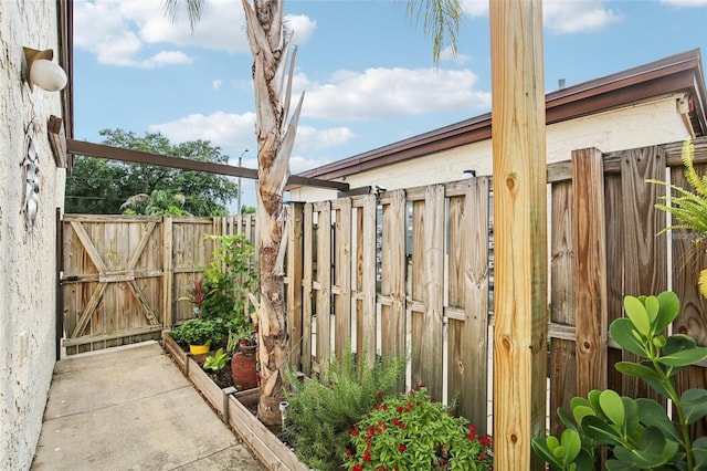 view of patio with fence and a gate