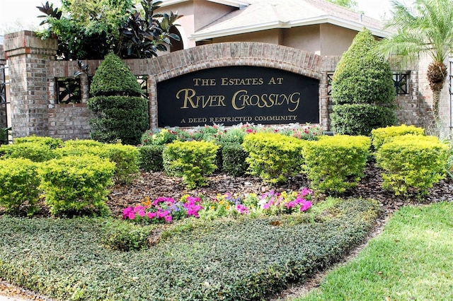 community / neighborhood sign featuring an attached garage