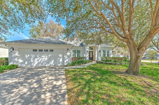 ranch-style house featuring concrete driveway, stucco siding, an attached garage, and a front yard