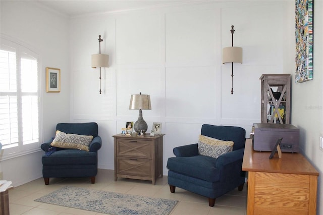 sitting room featuring light tile patterned floors and ornamental molding