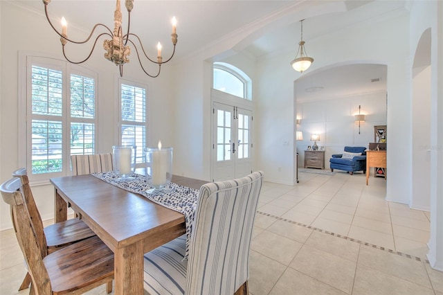 dining space featuring light tile patterned floors, baseboards, arched walkways, and a notable chandelier