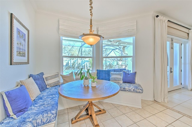 dining room featuring light tile patterned floors and crown molding