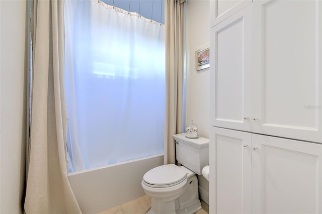 bathroom featuring shower / tub combo with curtain, toilet, and tile patterned floors