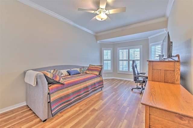 bedroom with ornamental molding, a ceiling fan, baseboards, and wood finished floors